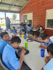 Children in Santa Elena eating lunch in their mandatory school uniforms. 